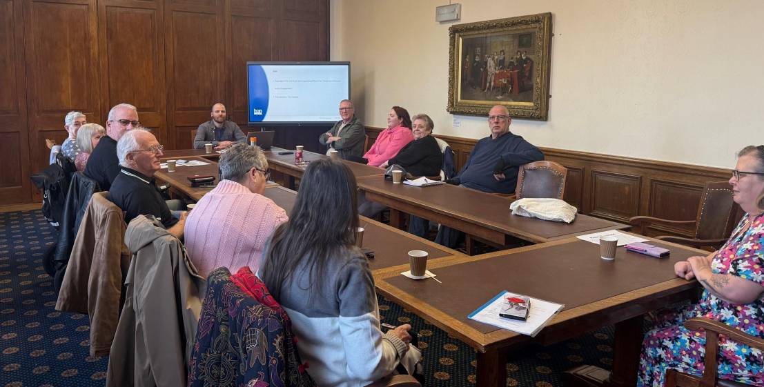 People sitting around a long meeting table